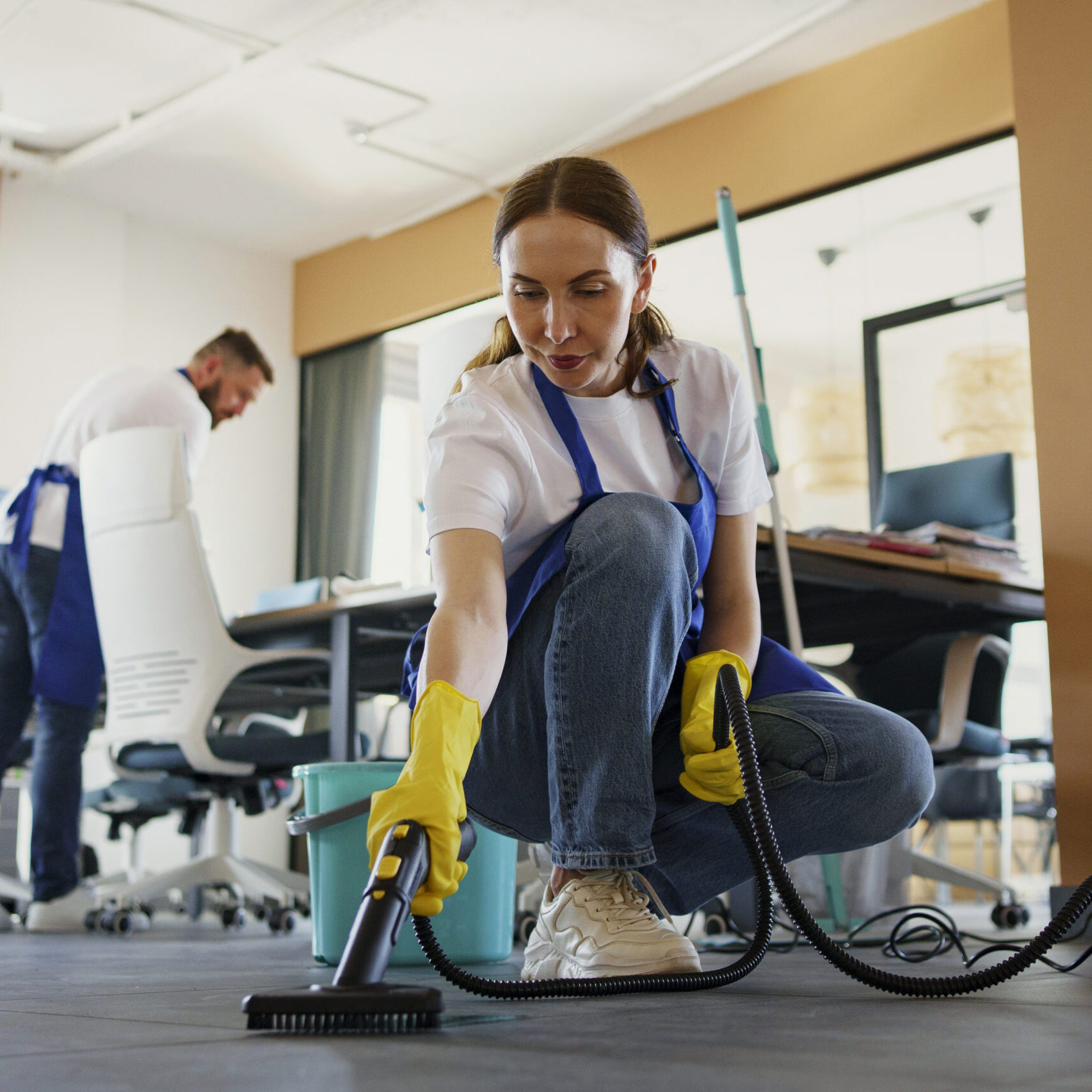 professional-cleaning-service-person-using-vacuum-cleaner-office